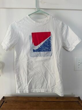 Nike youth White Tee with Red & Blue Graphic Swoosh.